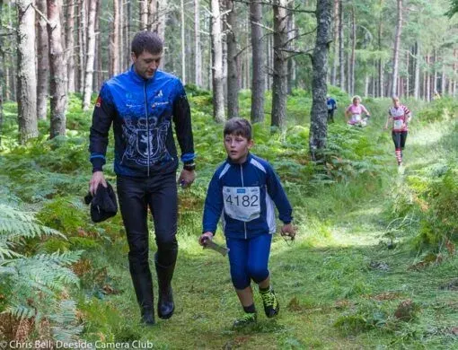 Orienteers walking through the forest at an event