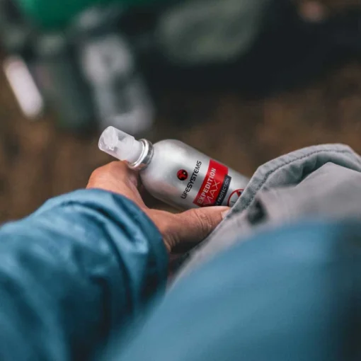lifesystems-expedition-max-mosquito-repellent-lifestyle Traveller putting in his pocket Lifesystems Expedition MAX mosquito repellent before tropical travel