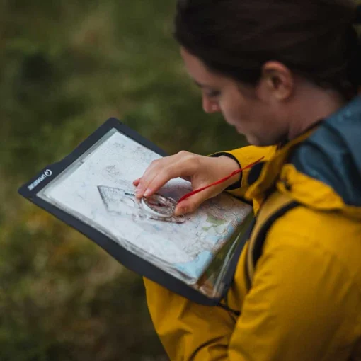 lifesystems-waterproof-case-map-case-lifestyle Hiker using a Lifesystems waterproof map case during outdoor navigation