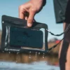 lifesystems-waterproof-phone-case-plus-grey Person using a smartphone inside a Lifesystems waterproof phone case outdoors