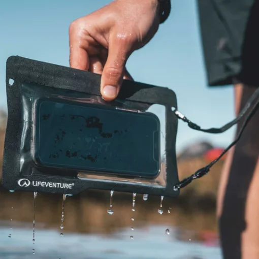 lifesystems-waterproof-phone-case-plus-grey Person using a smartphone inside a Lifesystems waterproof phone case outdoors