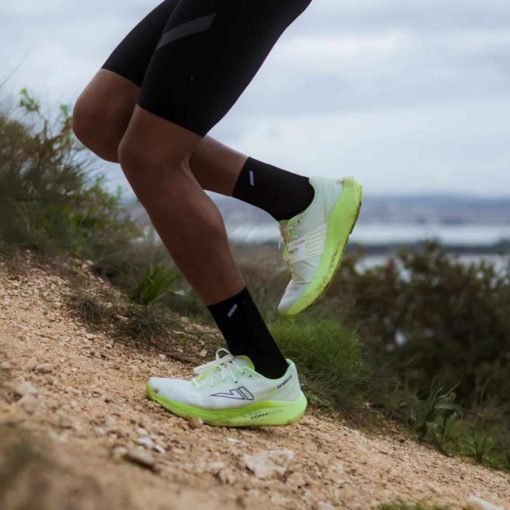 VJ-FZN-Aerofly-white-green-trail-running-shoes-model Runner wearing VJ FZN Aerofly trail running shoes on a trail